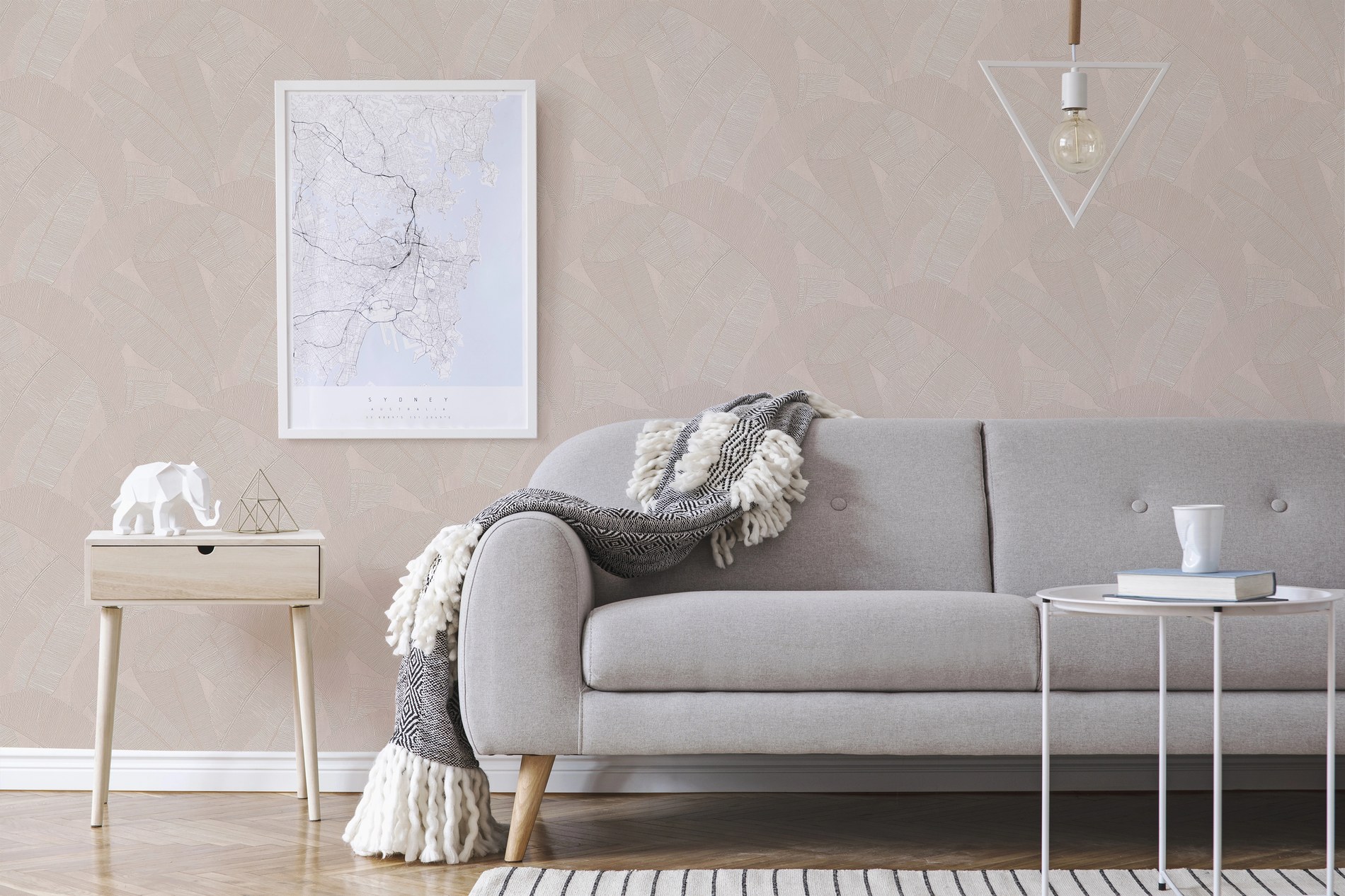 Banyan wallpaper behind a grey sofa