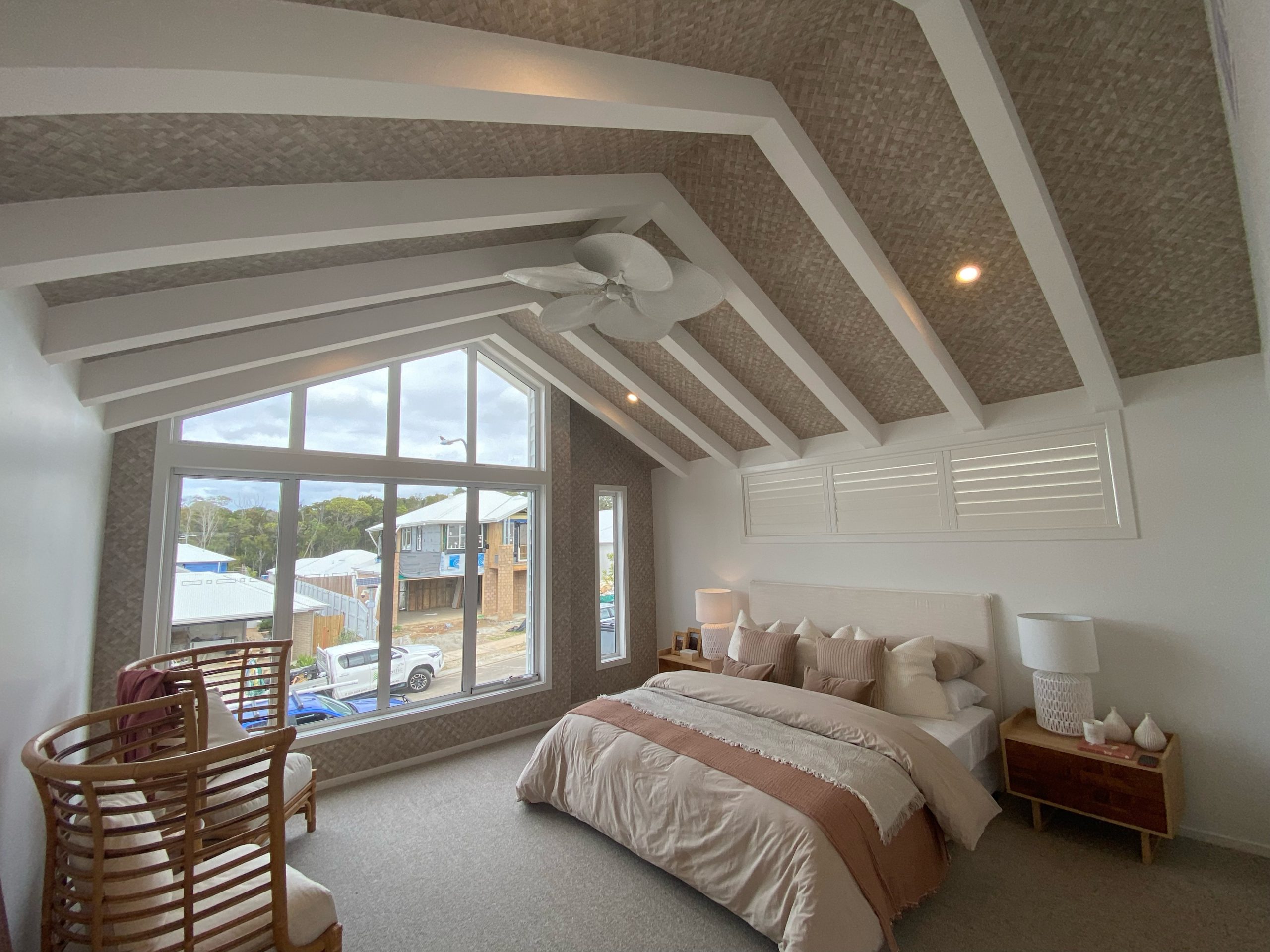 Brighton Homes coastal wallpaper on ceiling in a luxury bedroom in raffia weave installed bythe wallpaper experts
