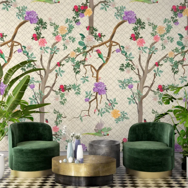 Parakeet Chinoiserie wallpaper featuring a cream backdrop with bamboo trellis and branches with birds. This is a wallpaper with the image showing 2 green fabric chairs and gold side table