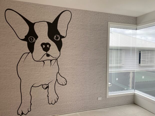 Brighton Homes fun mural of a dog on a faux brick wallpaper