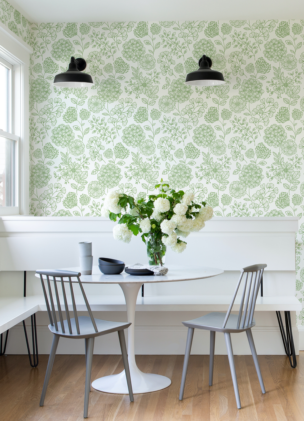 Light green floral wallpaper matches with white timber