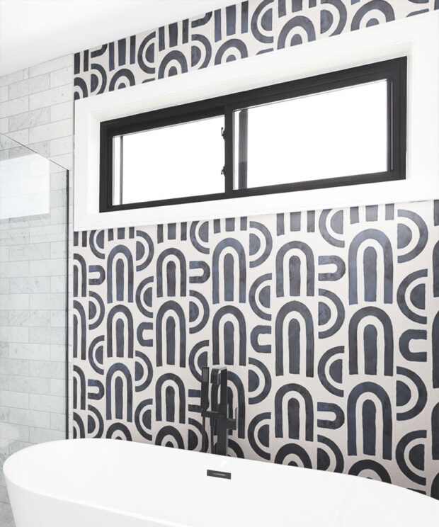 Graphic shapes in monochrome wallpaper in a bathroom