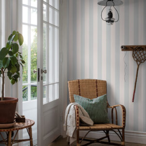 Stylish entry of country style home features stripe wallpaper