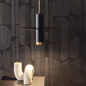 Styled room shot of lighting in front of Ovala wallpaper