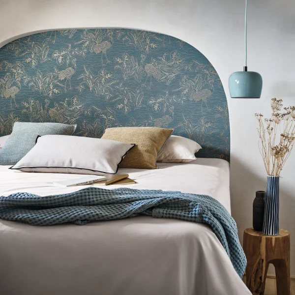 Modern bedroom with curved bedhead detail featuring Casamance Mirador bird wallpaper
