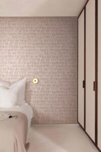 Shell Pink tactile lined wallpaper in a modern bedroom