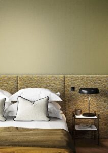 Lux Khaki Green textured wallpaper above bedhead