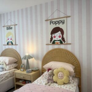 Pink stripe wallpaper in little girls bedroom
