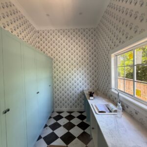 Traditional wallpaper in a small scale pattern installed in a butlers pantry