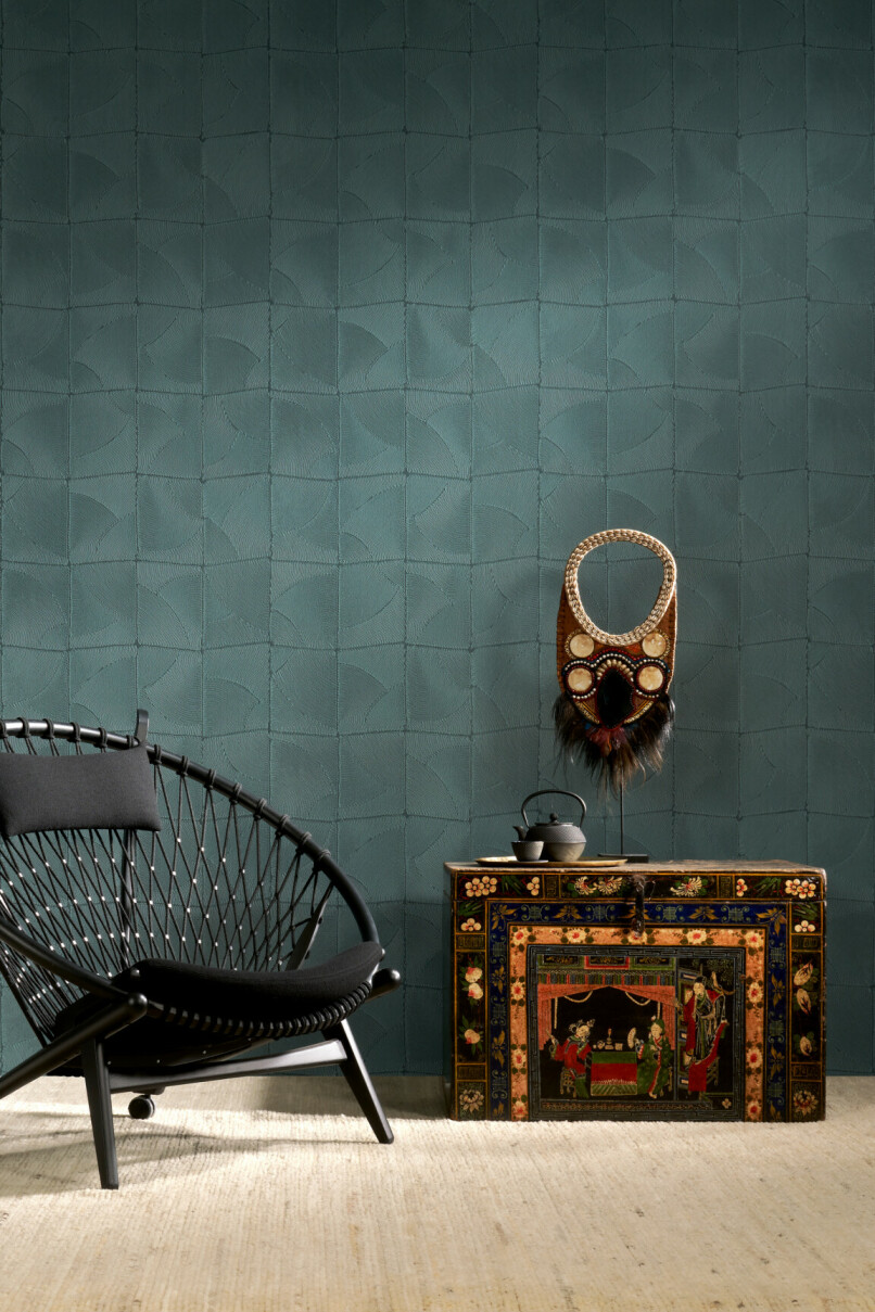 Petrol green wallpaper that is organic textured vinyl in a tribal style room