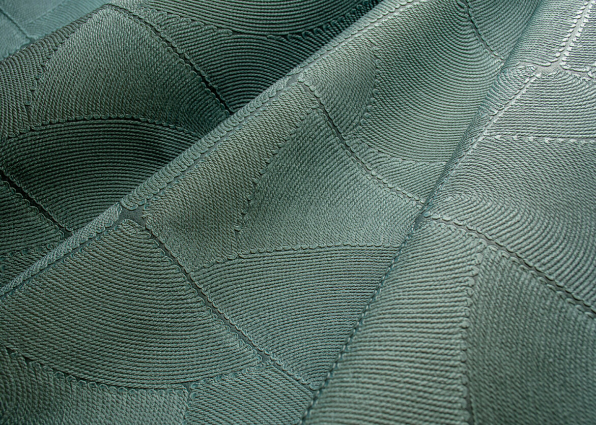 Wave roll of turquoise textured wallpaper