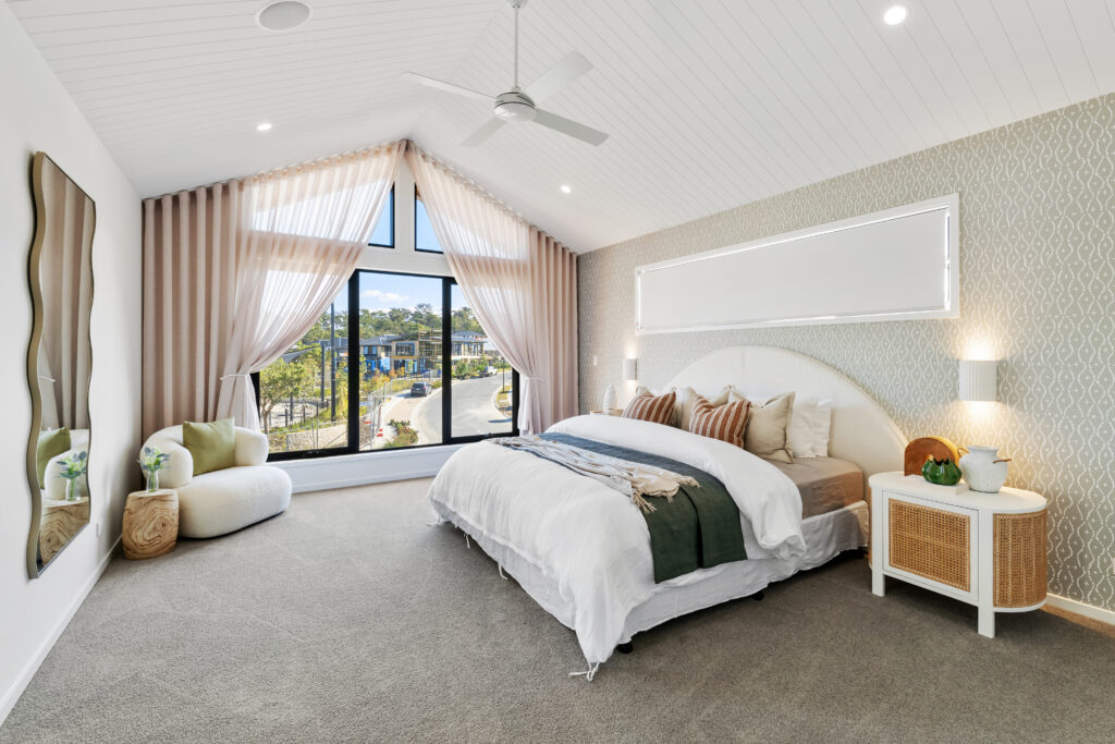 Grand master bedroom with green wallpaper on bedhead wall