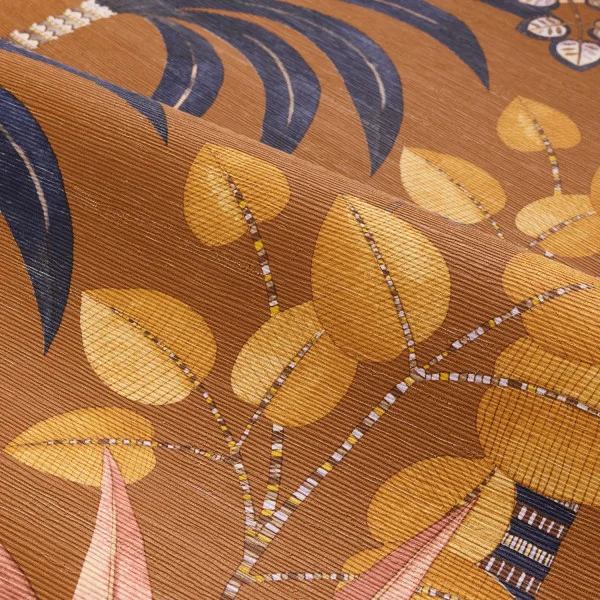 Close up on textured roll of palm tree wallpaper in burnt orange