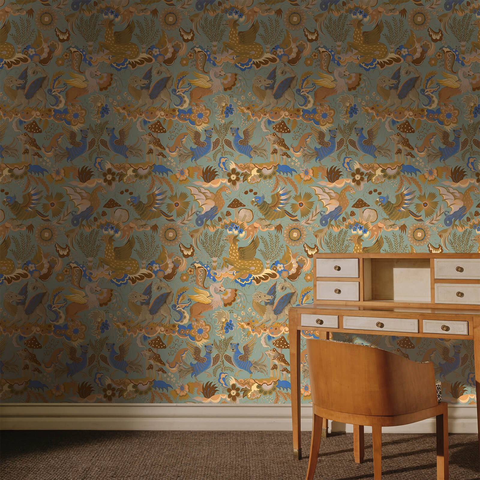 A whimsical wallpaper of toadstools and dragons in a home office