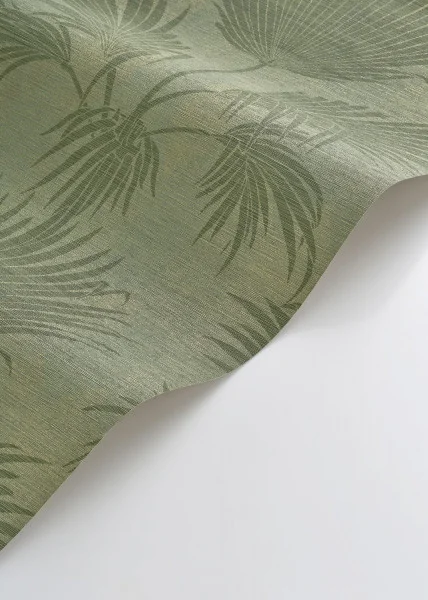 A roll of green palm leaf wallpaper