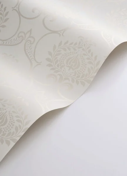 A roll of white wallpaepr in a damask style
