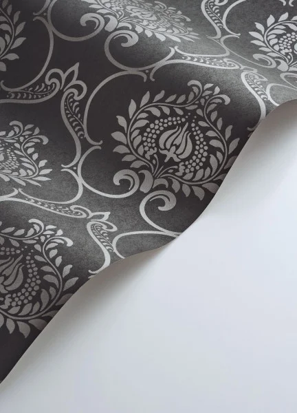 A roll of charcoal black damask wallpaper