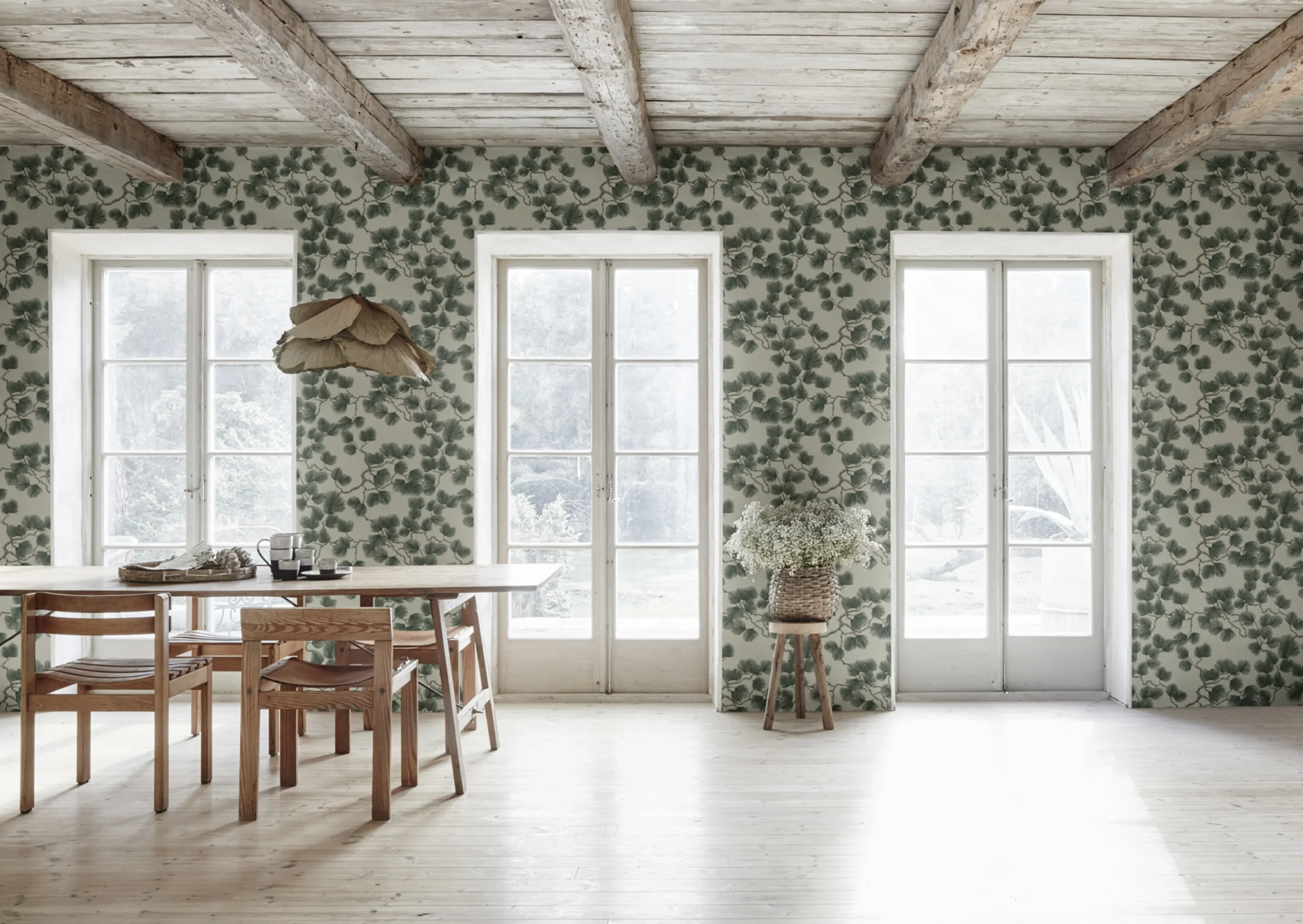 A bright open airy kitchen with Pine green wallpaper