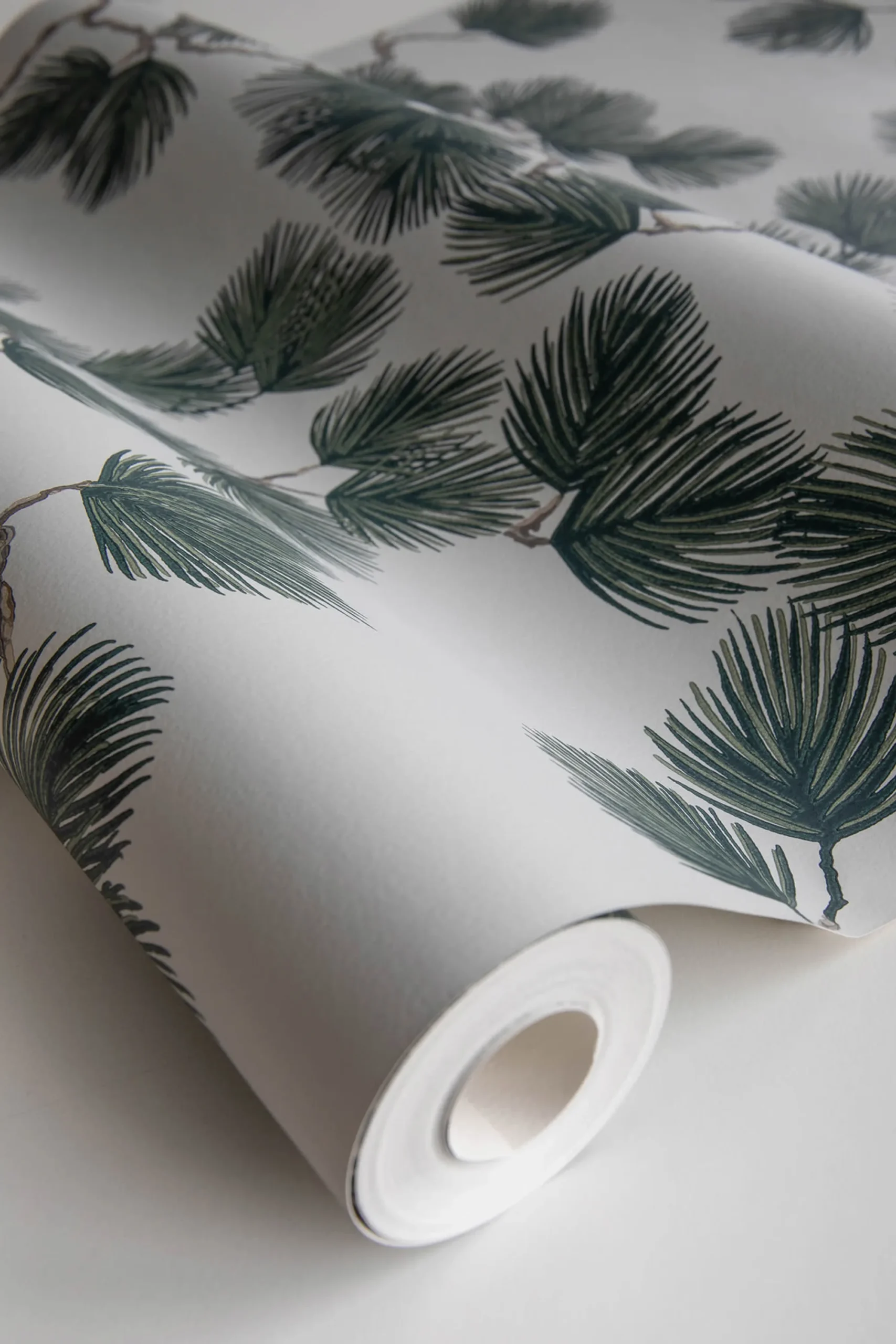 A roll of white and green pine wallpaper