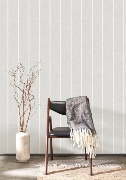 Grey linen look wallpaper with a stripe with modern furniture