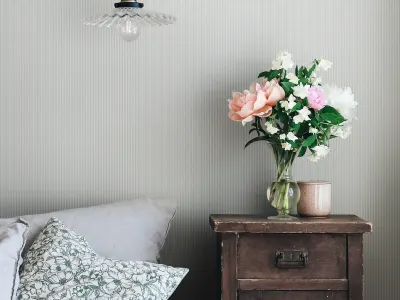Thin blue striped wallpaper in a farmhouse style bedroom