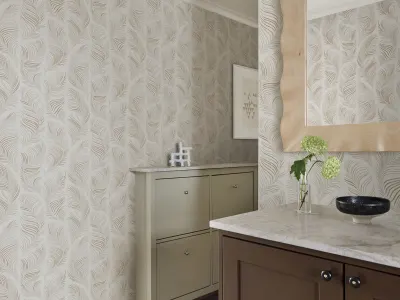 Beige wallpaper of feathers in a powder room