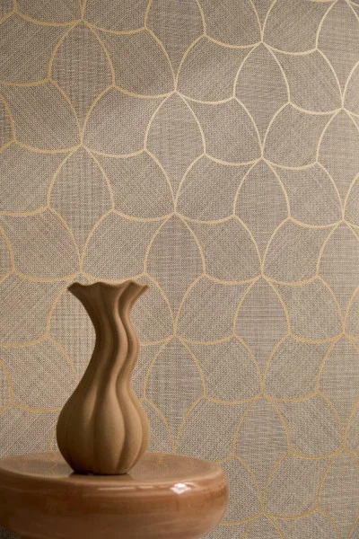 SEpia toned wallpaper that looks like basket weave and a soft metallic shaped detail