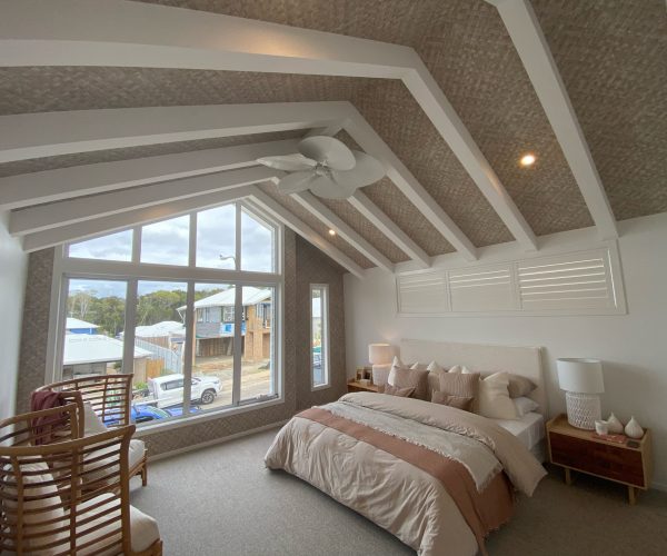 Brighton Homes coastal wallpaper on ceiling in a luxury bedroom in raffia weave installed bythe wallpaper experts
